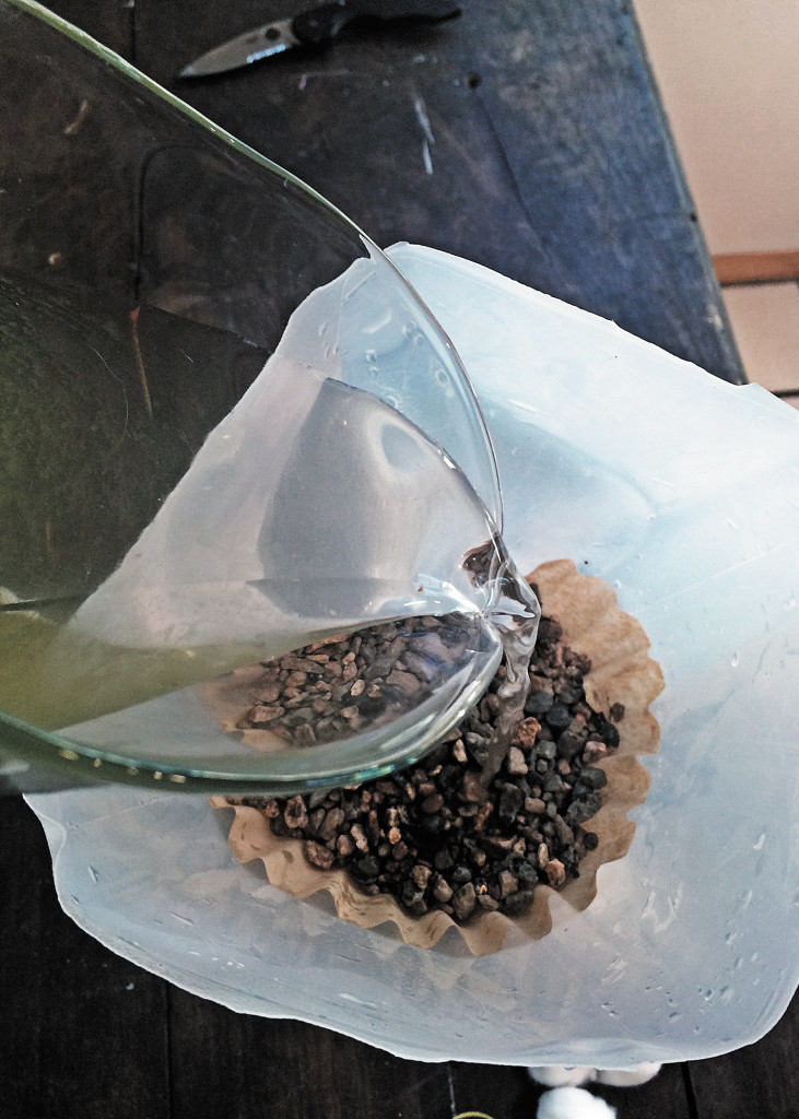 pouring-water-over-gravel-in-coffee-filter