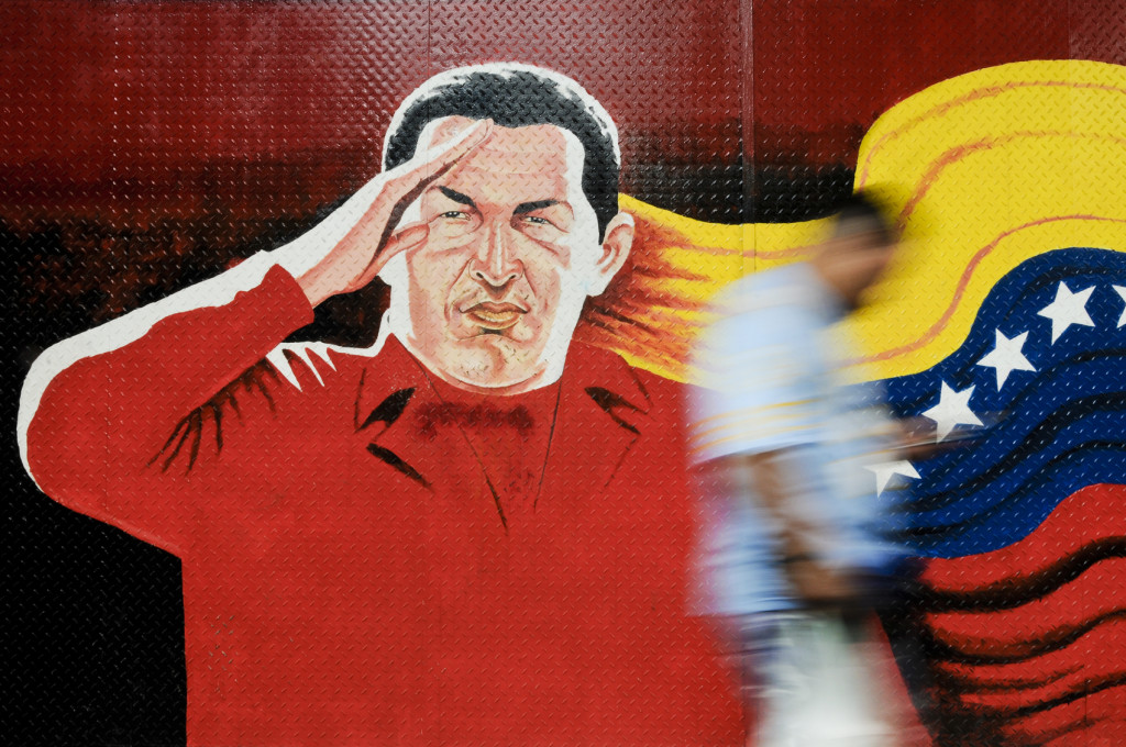 A giant mural of Hugo Chavez with the Venezuelan flag, located in central Caracas. Source: iStock / Thaddeus Robertson