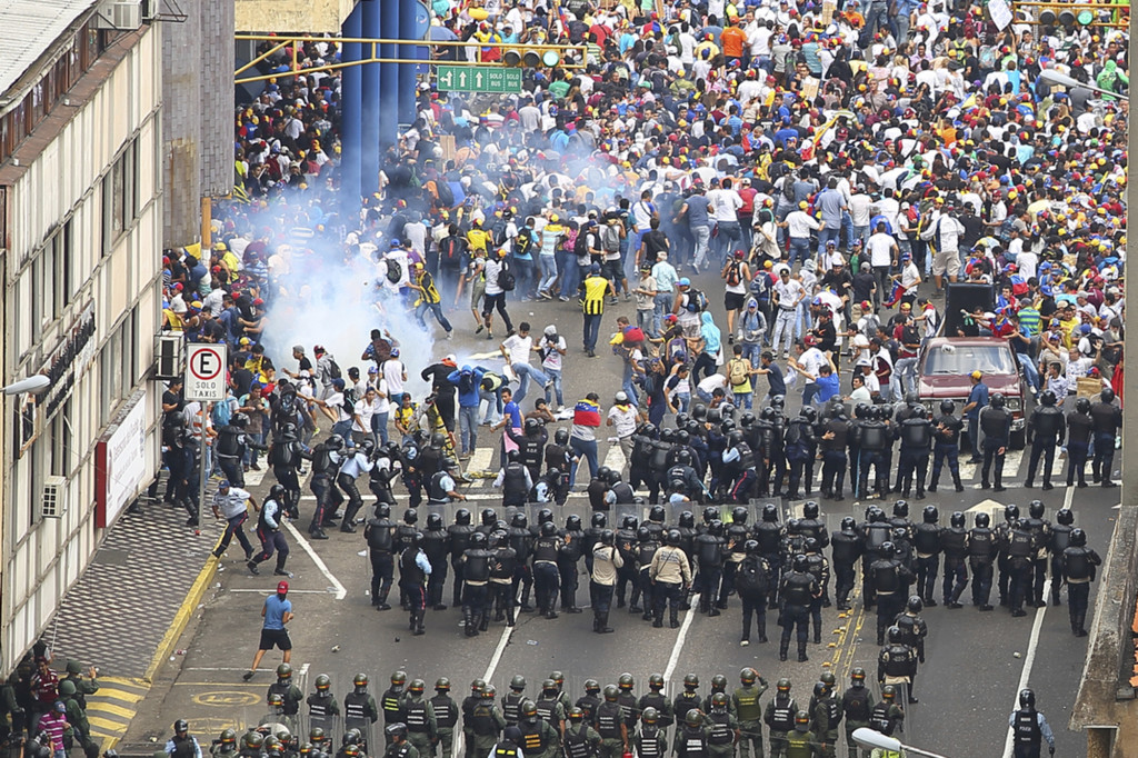National police forces use tear gas to disperse students and protesters on the streets of San Cristobal. Source: iStock / camacho9999