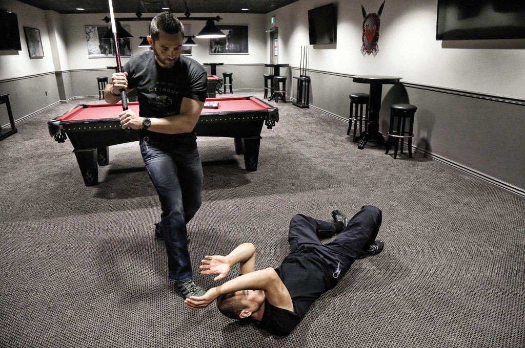 End Point of Zero Pressure: After talking down his aggressor doesn't work, Jared Wihongi slips out of range of the swing before crashing in and trapping Conrad Bui's arms. He then takes Bui down, strips the pool cue, and can now counterattack, scan for other bad guys, or make an escape.