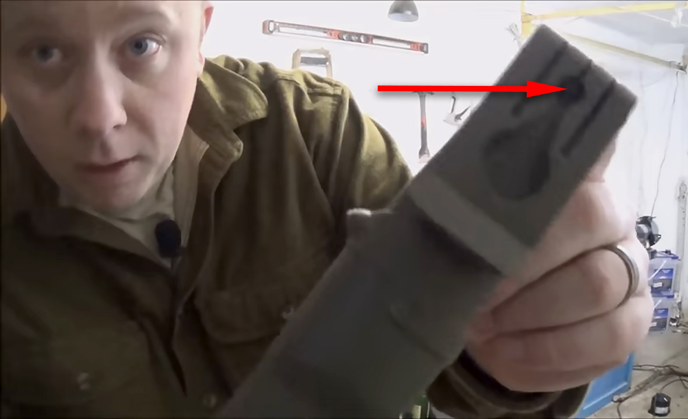 YouTube host MD Outdoor Reviews demonstrates a key feature of the Morakniv sheath.