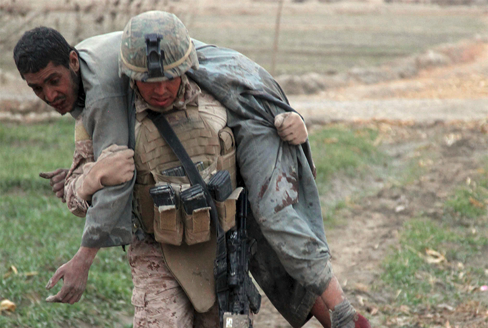 The fireman's carry positions the casualty's torso across your shoulders. Photo: Lance Cpl. Jorge A. Ortiz, U.S. Marine Corps