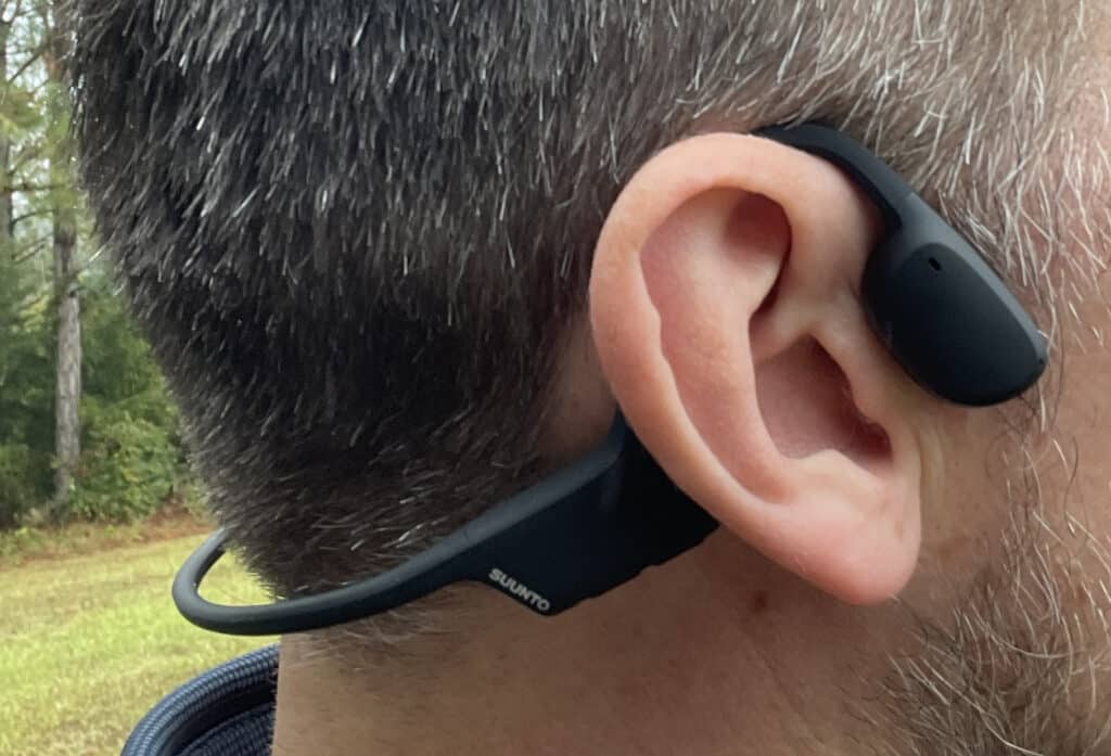 adult male wearing suunto's bone conduction headphones.