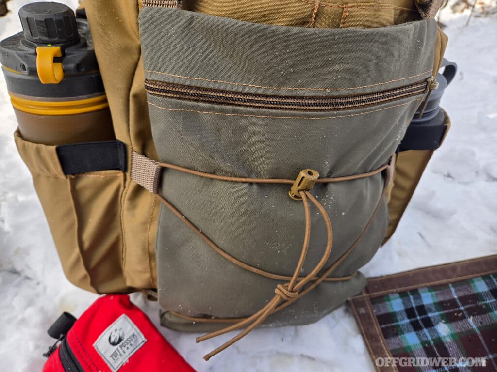 The optional front pouch of the Discovery M1 that contains various survival kit items